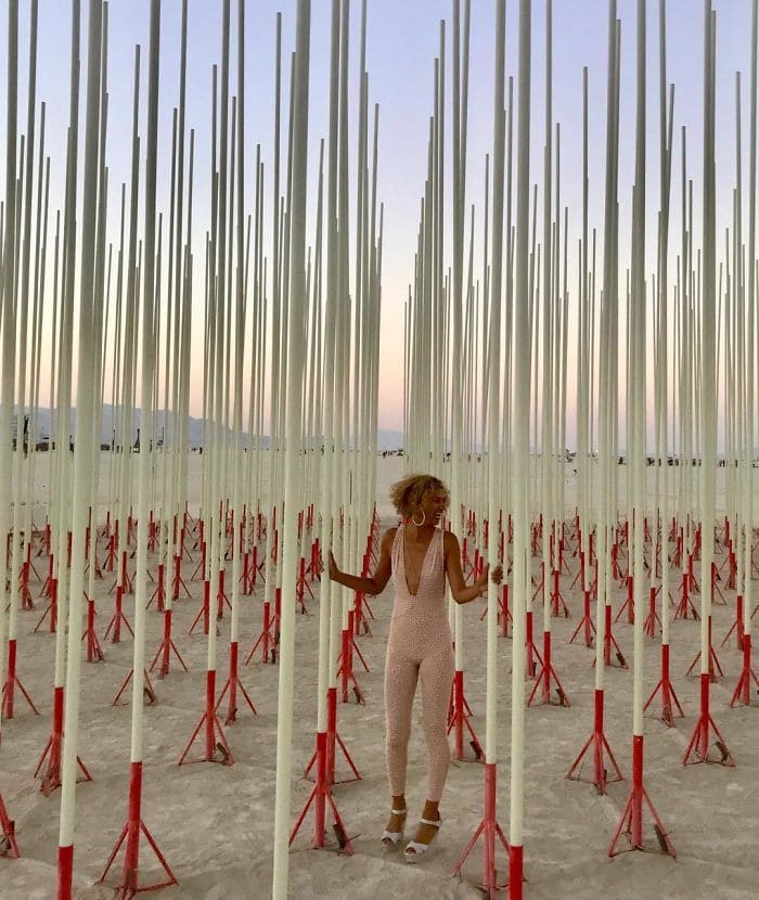 Woman surrounded by white and red sticks