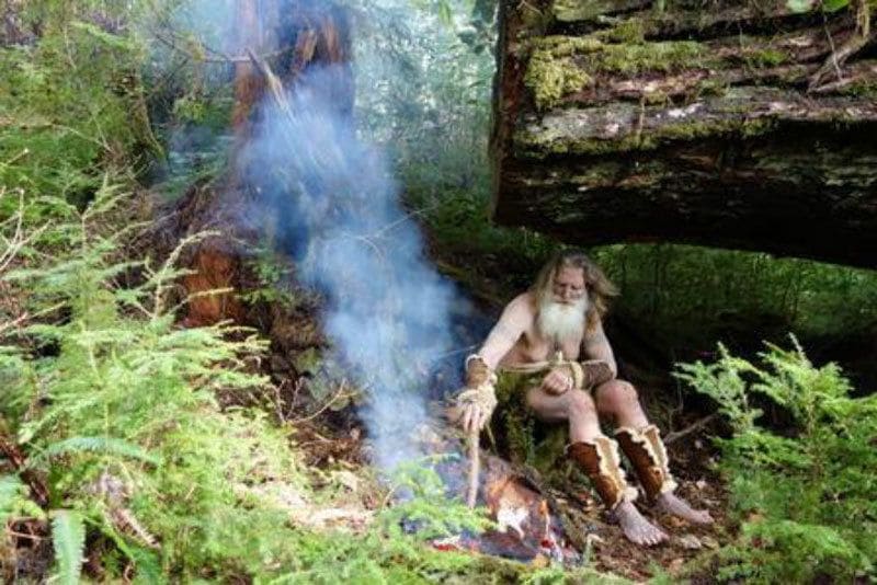 Mick Dodge is sitting in the forest kindling his fire 