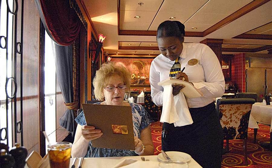 A woman ordering food in a cruise ship restaurant 
