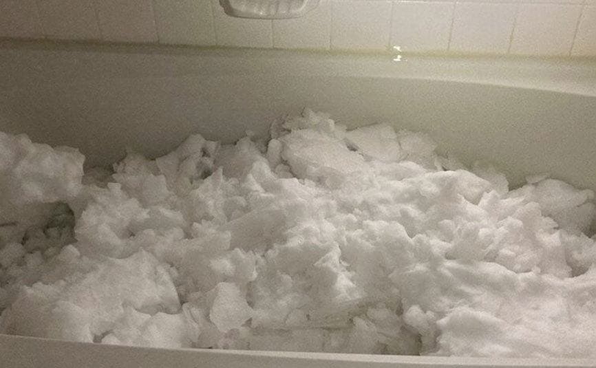 A bathtub filled with snow. 
