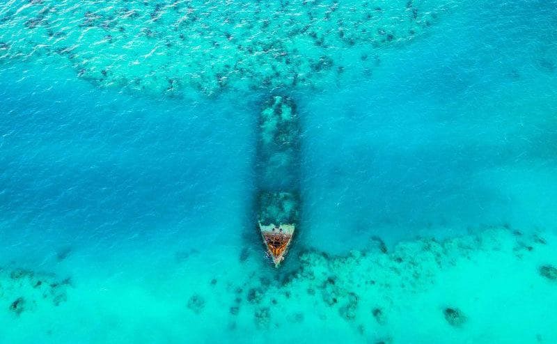 An aerial view of a shipwreck in the ocean near Bermuda is seen thanks to the shallow waters.