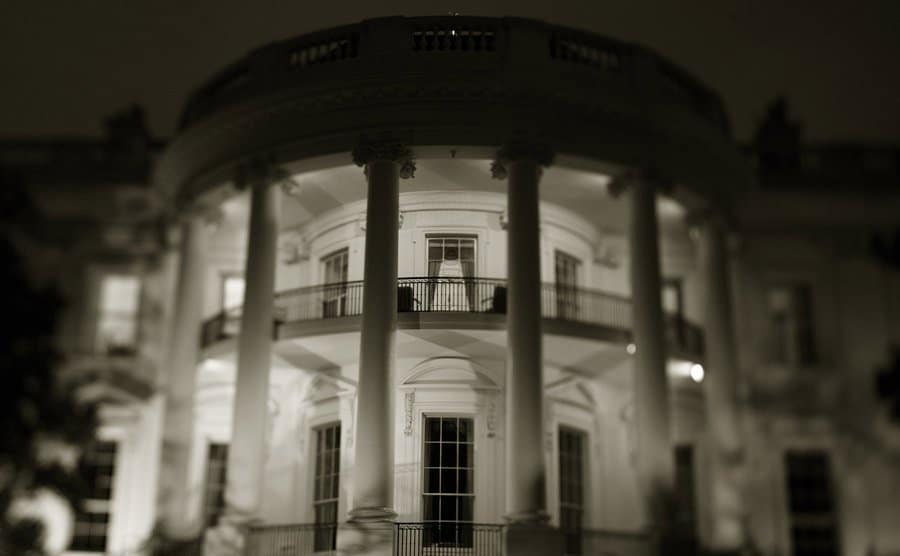 A picture of The White House at night.