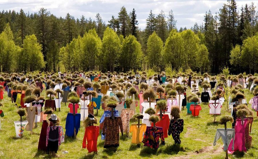 A thousand scarecrows are standing in a field. 