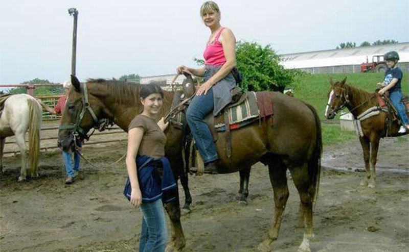 Charla Nash with her daughter, Brianna, on a horse ranch. 