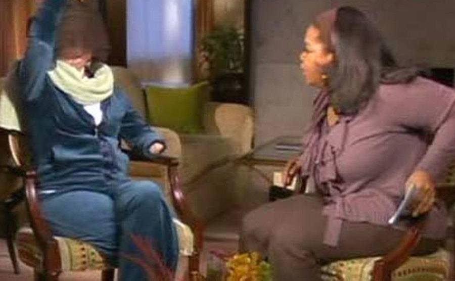 Nash speaks with a face-covering Oprah. 