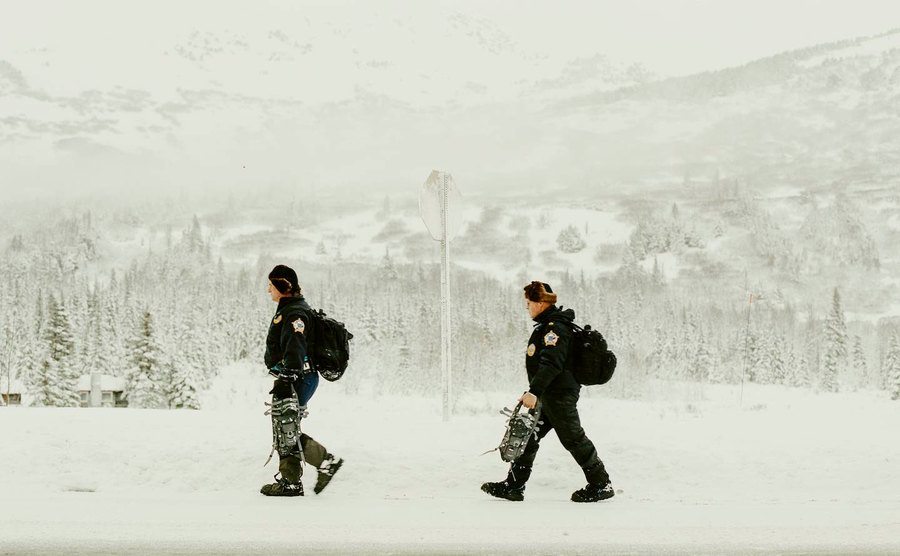 Troopers walk the Alaska wilderness.